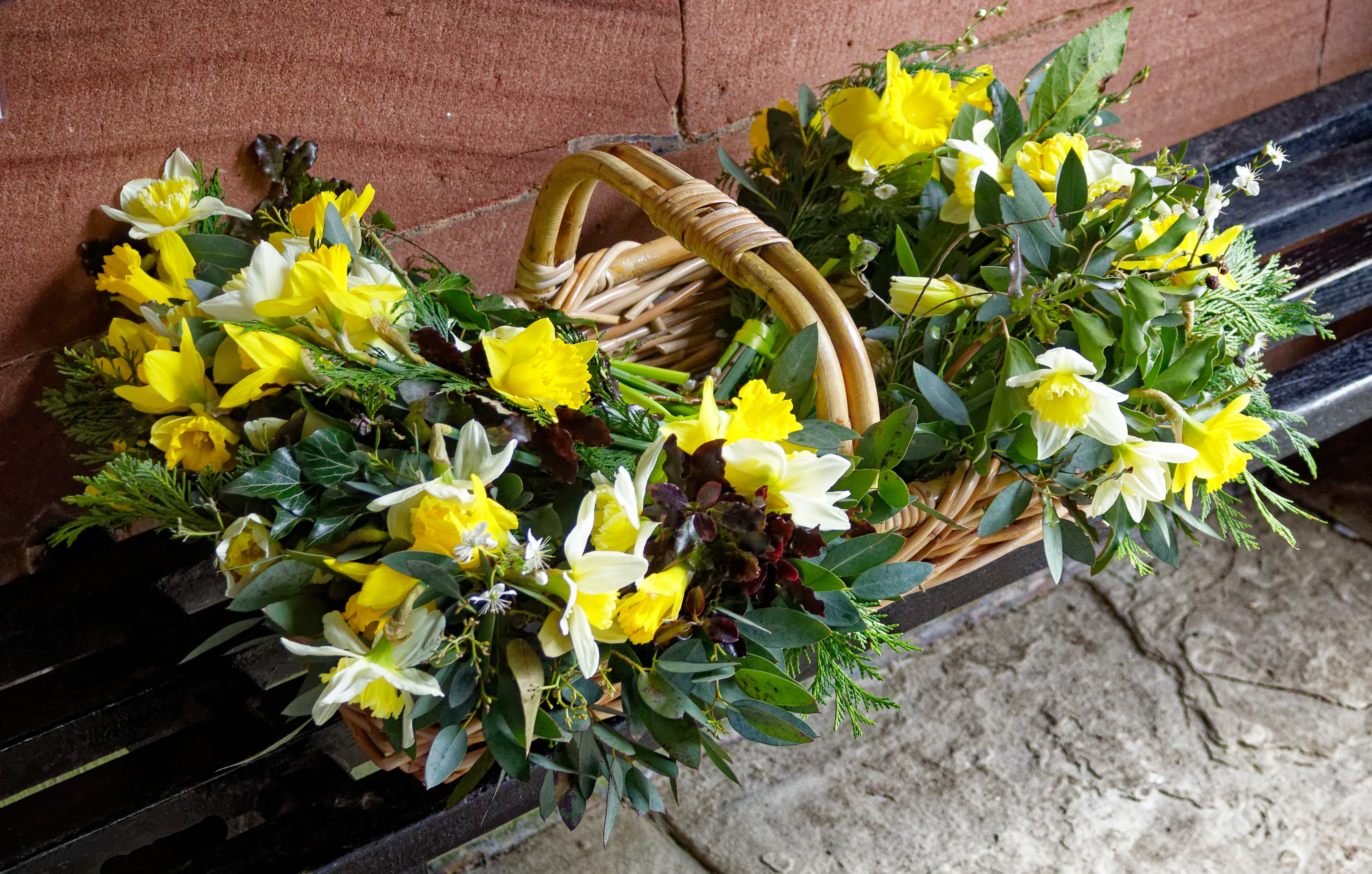 A basket of spring flowers in the church porch.