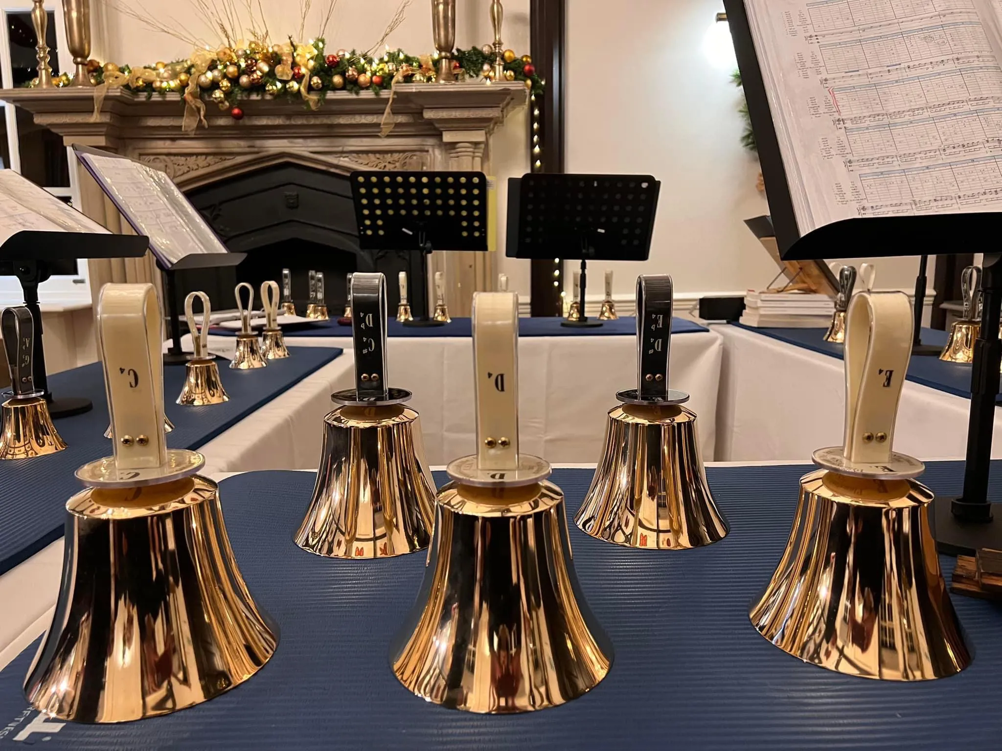 A photo of brass handbells laid out on a table