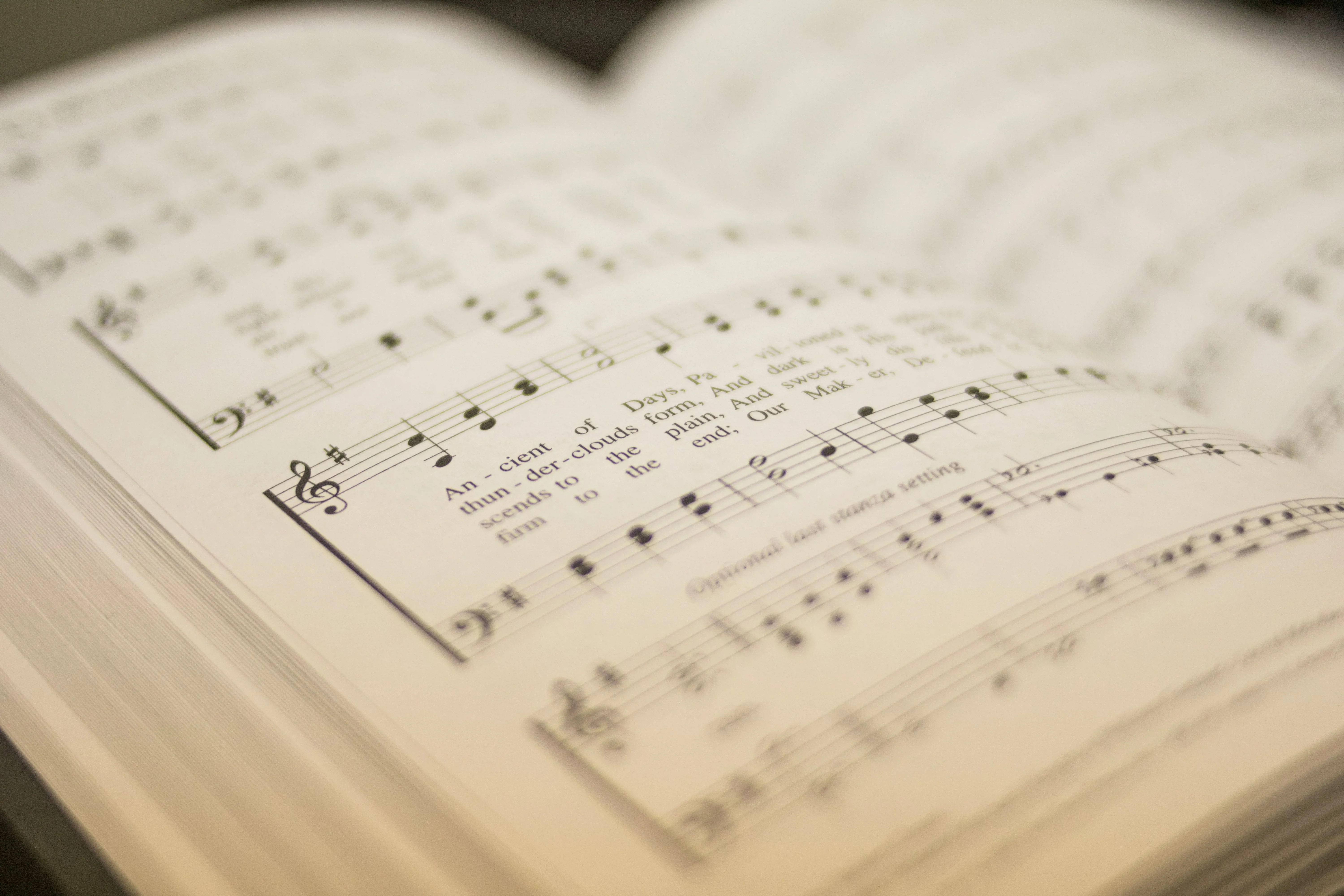 An open hymn book with musical score