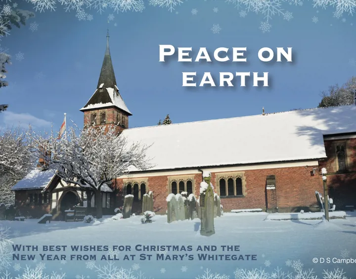 A photo of St Mary's church covered in snow with blue sky behind