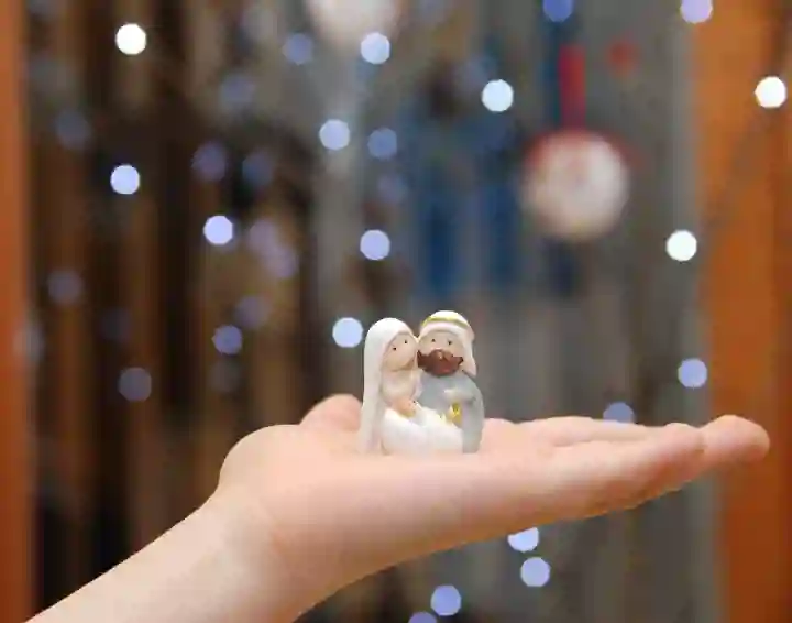 Child's open hand with ceramic nativity figures