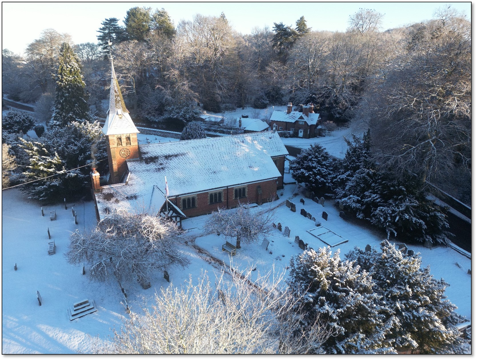 An aerial shot of St Mary's Church and graveyard covered in snow