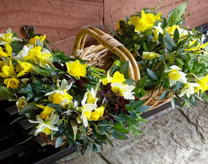 A basket of spring flowers in the church porch.