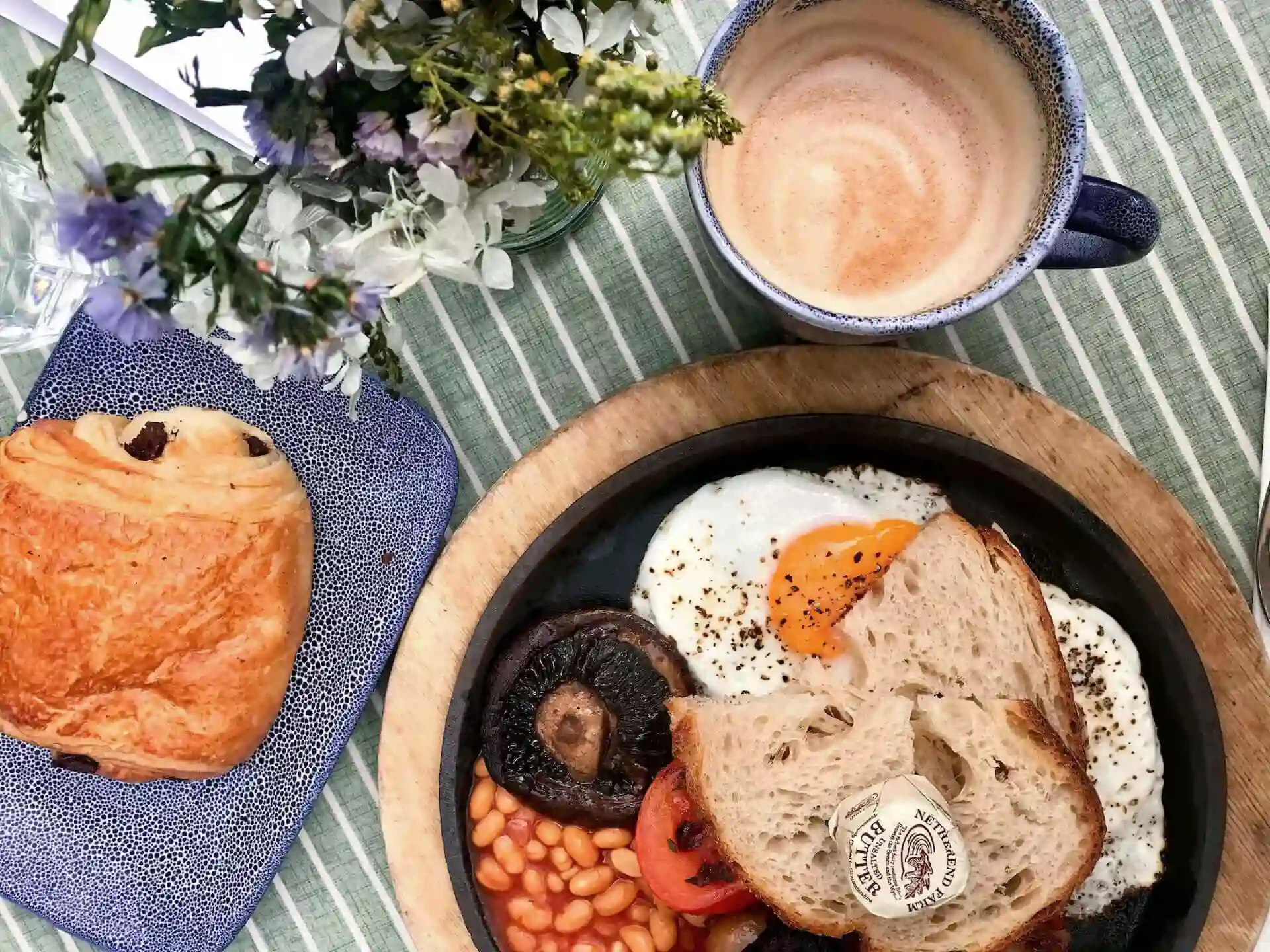 English breakfast with a cup of coffee and a pain au chocolat