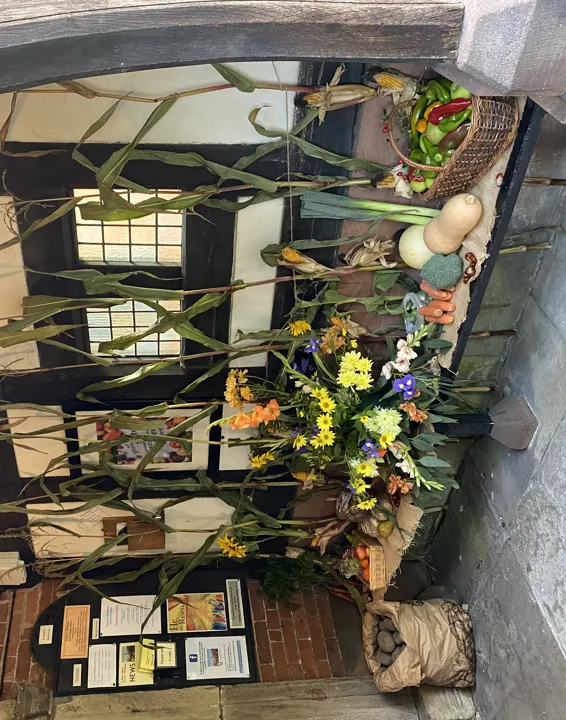 Church porch decorated with fruit and vegetables for Harvest Festival.